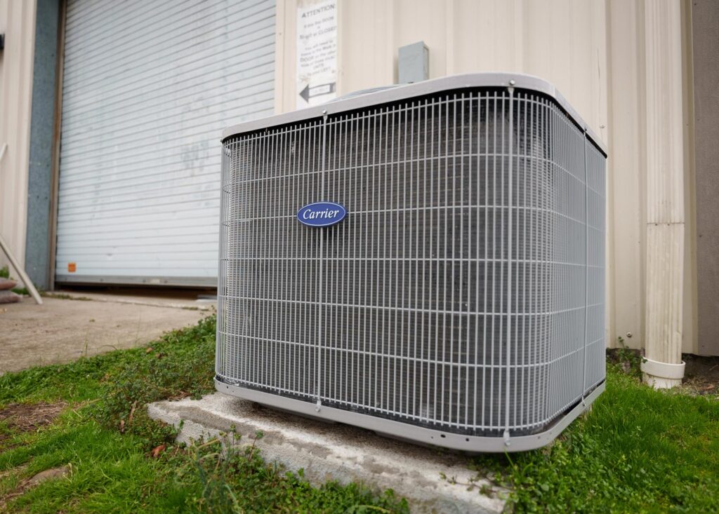 A Carrier air conditioning unit installed on the exterior of a building in Columbus GA