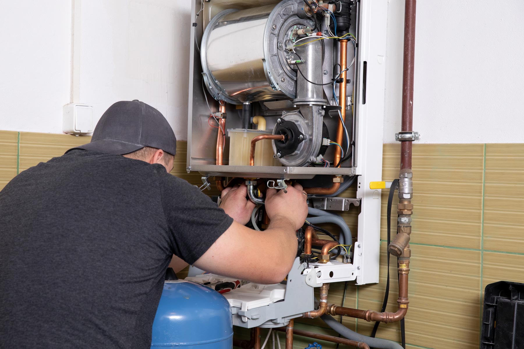A technician working on a boiler unit in Columbus, GA